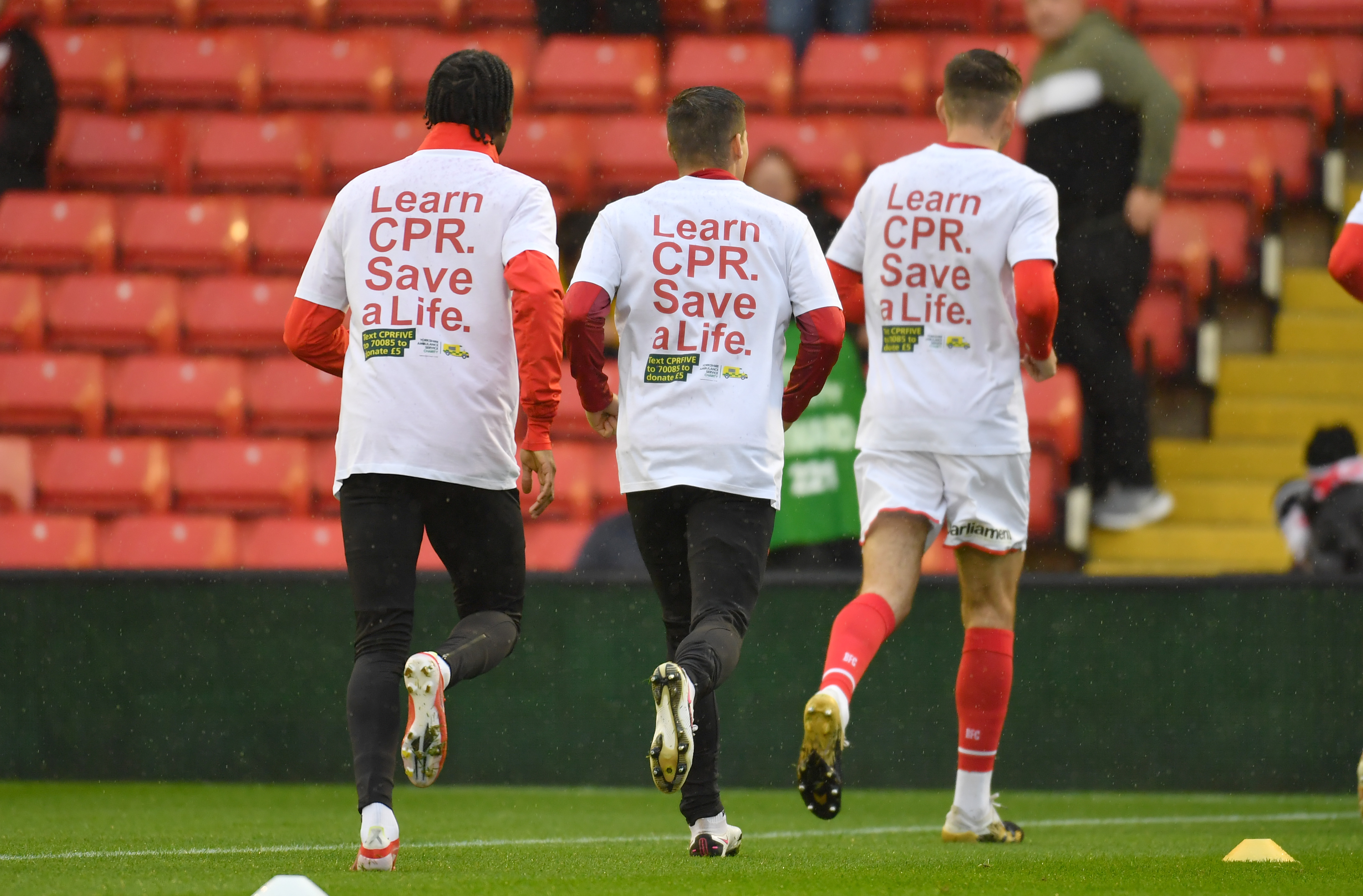 Barnsley FC player warming up wearing the Learn CPR. Save a Life t-shirts.