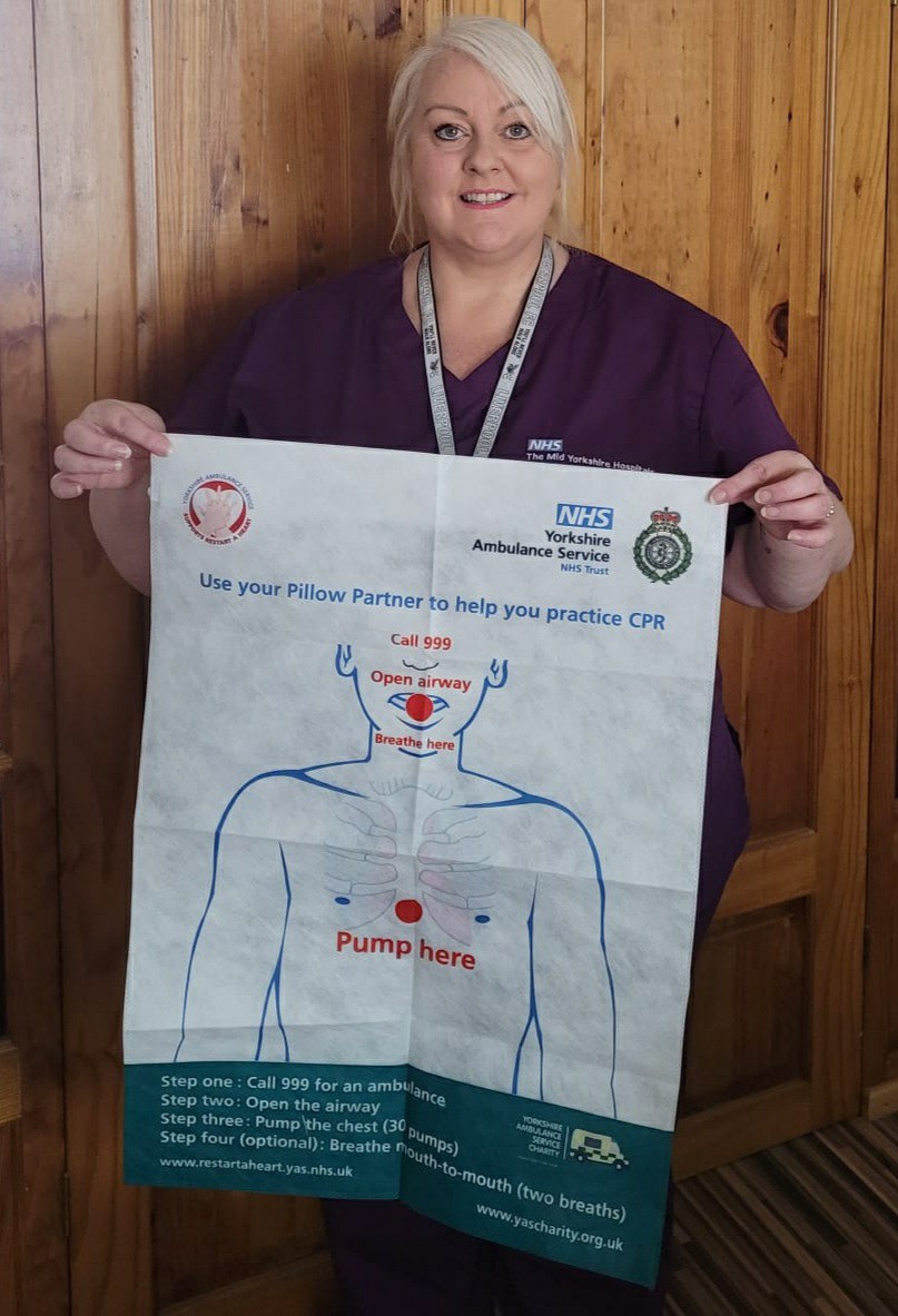 Jo Stanley with a Pillow Partner CPR training aid