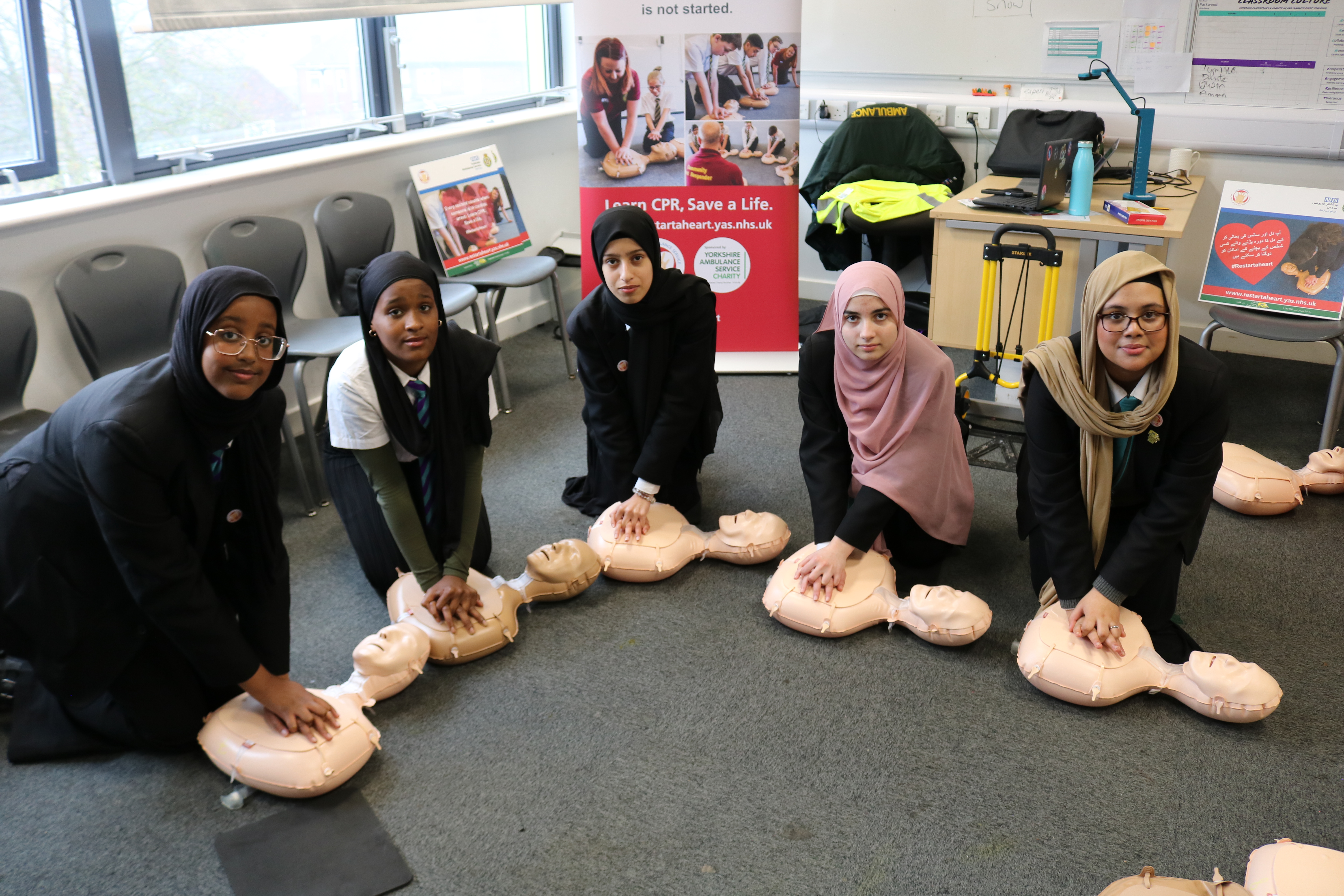 Students at E-ACT Parkwood Academy doing CPR on manikins